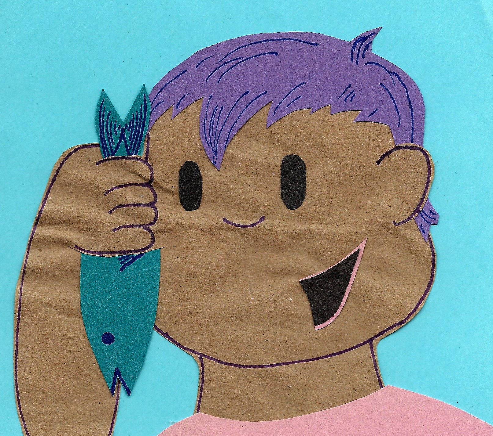 The boy holds up a small fish in his hand to look closely at it, a big smile on his face.
