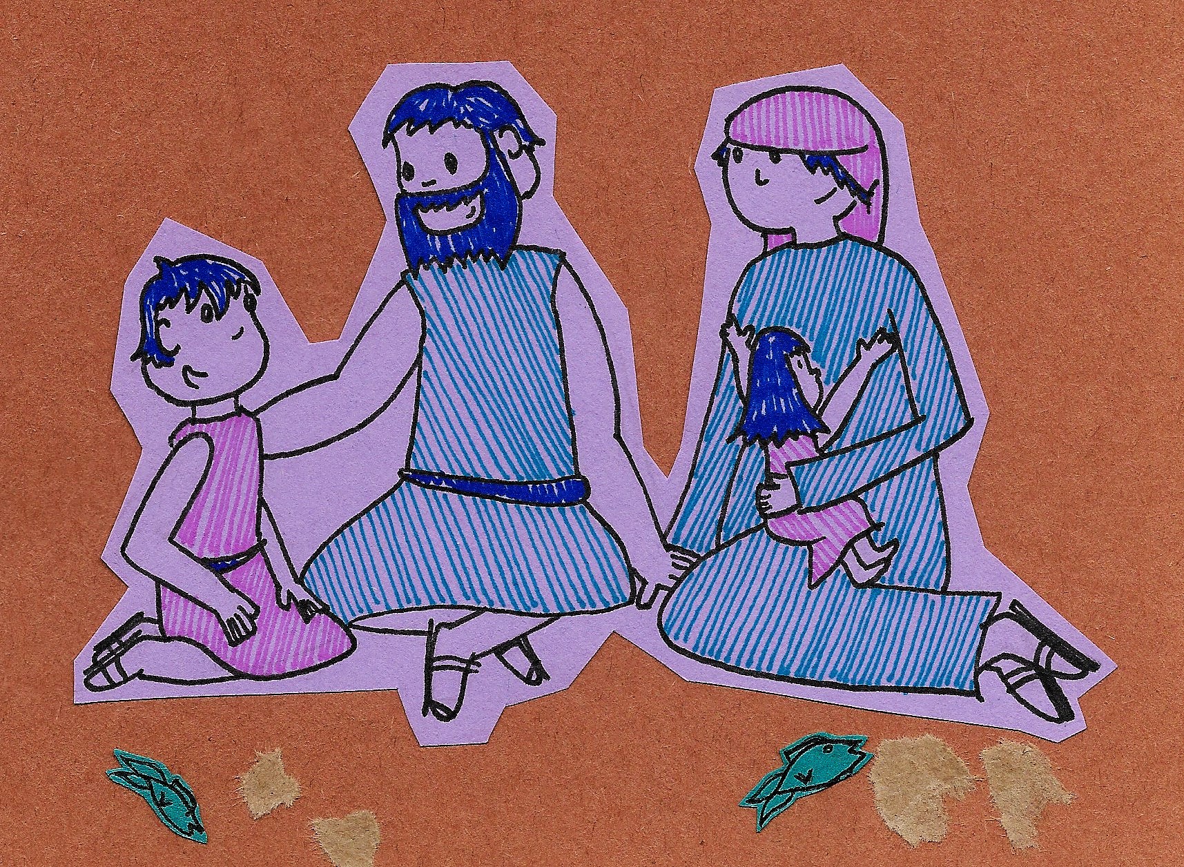 The boy sits with his family on the ground, surrounded by bread and fish.